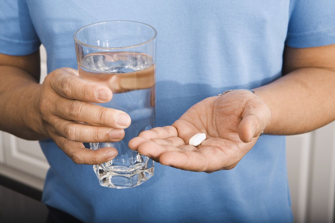 a man taking a pill for parasites